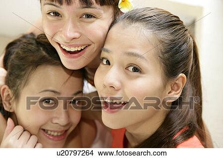 Close-up of young women smiling. View Large Photo Image Picture - Close-up of young women smiling.. Fotosearch