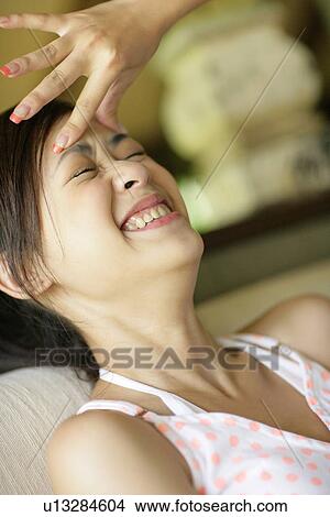 View of a young woman with headache. View Large Photo Image Picture - View of a young woman with headache.. Fotosearch