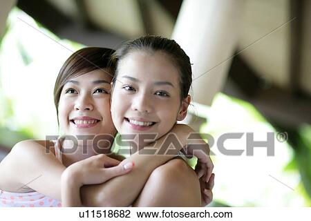 View of young women hugging. View Large Photo Image Stock Image - View of young women hugging.. Fotosearch
