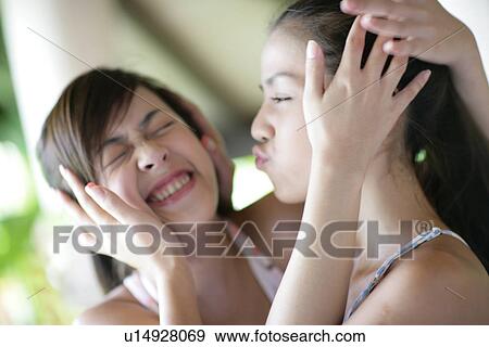 Stock Photo - View of young women hugging.. Fotosearch