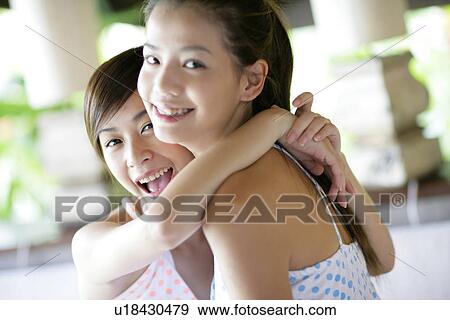View of young women hugging. View Large Photo Image Stock Photo - View of young women hugging.. Fotosearch