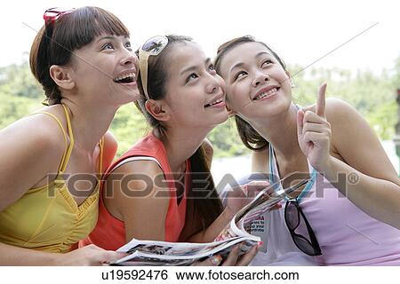 View of young women looking up. View Large Photo Image Stock Photograph - View of young women looking up.. Fotosearch