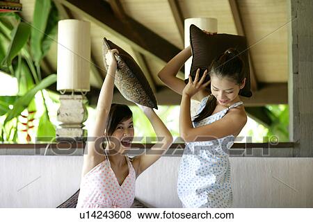 View of young women pillow fighting. View Large Photo Image Stock Photo - View of young women pillow fighting.. Fotosearch