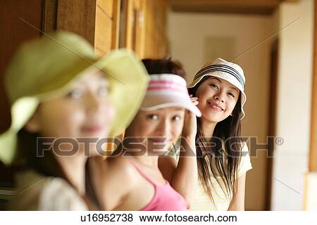 Stock Photo - View of young women smiling.. Fotosearch