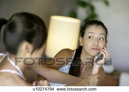 View of young women talking on mobile phone. View Large Photo Image Picture - View of young women talking on mobile phone.. Fotosearch