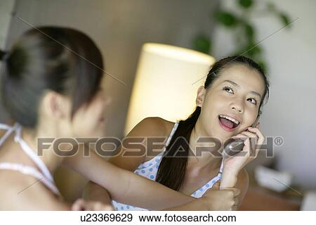 View of young women talking on mobile phone. View Large Photo Image Stock Photo - View of young women talking on mobile phone.. Fotosearch