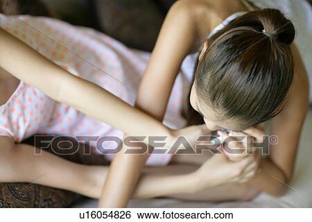 View of young women talking on mobile phone. View Large Photo Image Stock Photograph - View of young women talking on mobile phone.. Fotosearch