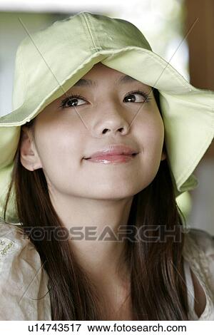 Stock Photo - Portrait of a young woman staring.. Fotosearch