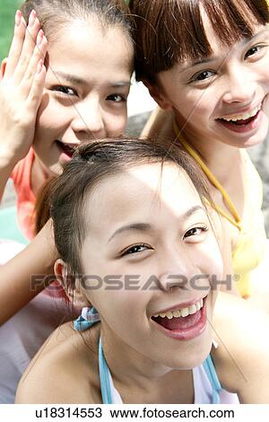 Stock Image - Portrait of young women smiling.. Fotosearch