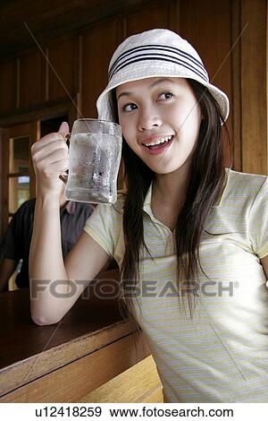 Stock Photo - View of a young woman drinking water.. Fotosearch