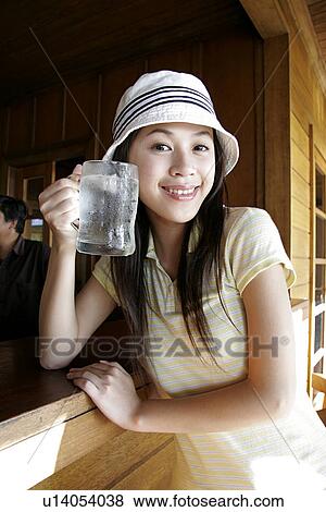 View of a young woman drinking water. View Large Photo Image Stock Photo - View of a young woman drinking water.. Fotosearch