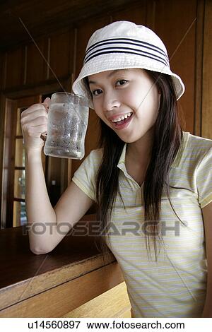 View of a young woman drinking water. View Large Photo Image Stock Photo - View of a young woman drinking water.. Fotosearch