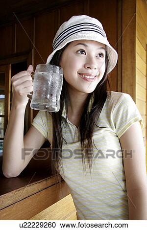 View of a young woman holding glass. View Large Photo Image Stock Image - View of a young woman holding glass.. Fotosearch