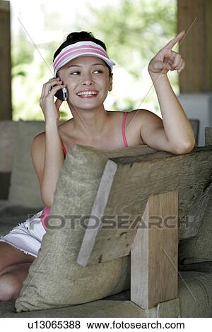 View of a young woman using mobile phone. View Large Photo Image Stock Photo - View of a young woman using mobile phone.. Fotosearch