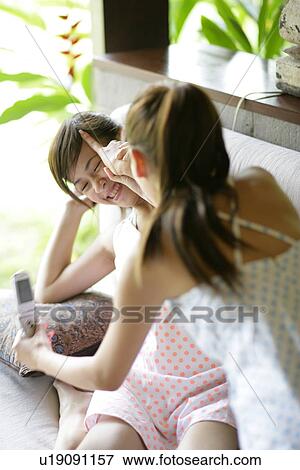 Stock Photo - View of playful young women.. Fotosearch
