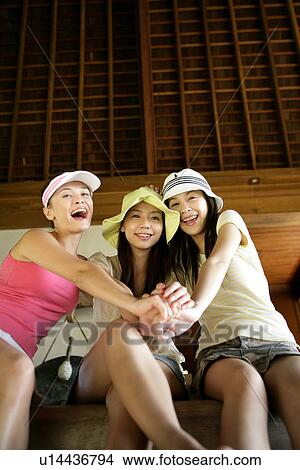 Picture - View of young women sitting.. Fotosearch