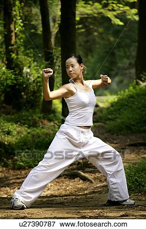 Stock Photo - View of a woman practicing karate.. Fotosearch