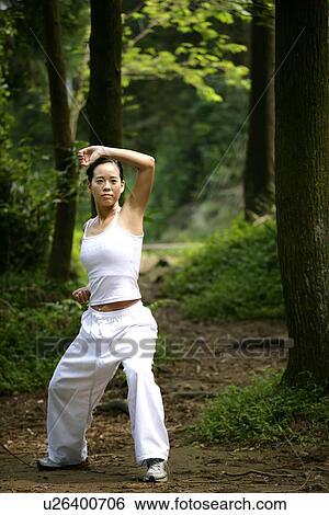 Stock Photograph - View of a woman practicing karate.. Fotosearch