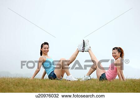 View of young women exercising on grassland. View Large Photo Image Stock Image - View of young women exercising on grassland.. Fotosearch