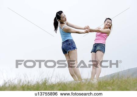 View of young women exercising on grassland. View Large Photo Image Stock Photograph - View of young women exercising on grassland.. Fotosearch