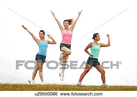 View of young women exercising on grassland. View Large Photo Image Stock Photograph - View of young women exercising on grassland.. Fotosearch