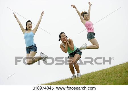 View of young women exercising on grassland. View Large Photo Image Stock Photography - View of young women exercising on grassland.. Fotosearch