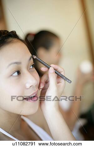 View of a woman applying cosmetic. View Large Photo Image Stock Image - View of a woman applying cosmetic.. Fotosearch
