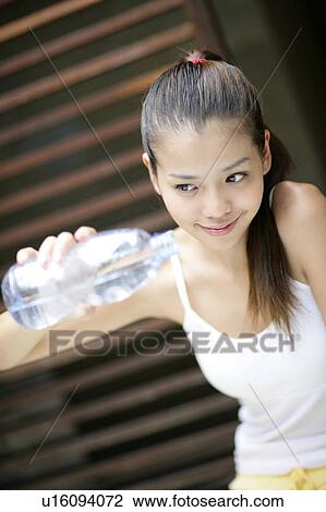 View of a woman with a bottle. View Large Photo Image Stock Image - View of a woman with a bottle.. Fotosearch