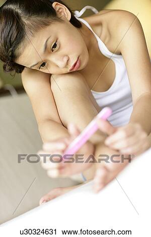 View of a young woman shaping her nails. View Large Photo Image Stock Image - View of a young woman shaping her nails.. Fotosearch