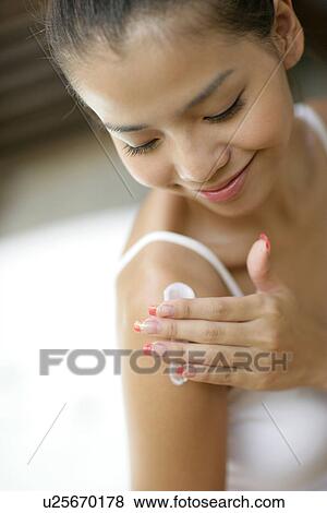 Woman applying a cream on her hands. View Large Photo Image Stock Photo - Woman applying a cream on her hands.. Fotosearch