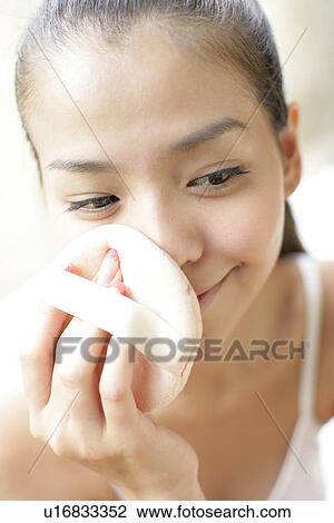 Woman applying powder puff on her face. View Large Photo Image Stock Image - Woman applying powder puff on her face.. Fotosearch