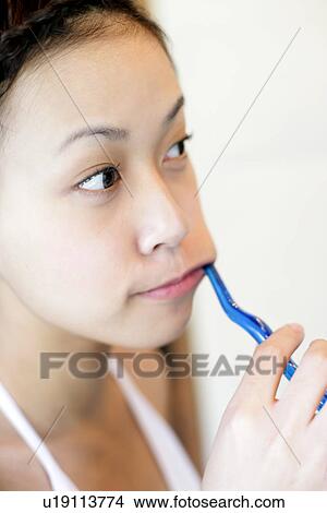 Picture - Woman brushing her teeth.. Fotosearch
