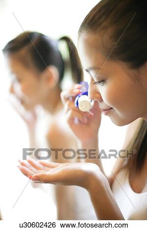 Woman squeezing cream from a tube. View Large Photo Image Stock Photograph - Woman squeezing cream from a tube.. Fotosearch