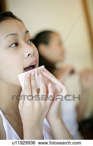 Stock Photograph - Woman wiping her face.. Fotosearch