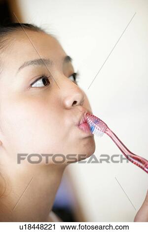 Close-up of a young woman brushing teeth. View Large Photo Image Stock Image - Close-up of a young woman brushing teeth.. Fotosearch