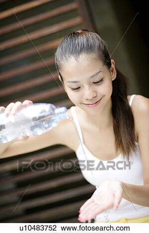 View of a young woman pouring water on hands. View Large Photo Image Stock Image - View of a young woman pouring water on hands.. Fotosearch