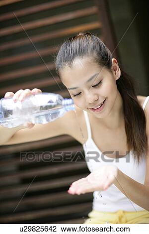 View of a young woman pouring water on hands. View Large Photo Image Stock Image - View of a young woman pouring water on hands.. Fotosearch