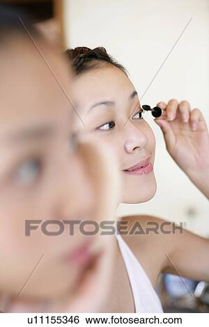 Woman applying an eye liner. View Large Photo Image Stock Photograph - Woman applying an eye liner.. Fotosearch