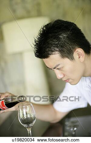 Man filling a glass. View Large Photo Image Picture - Man filling a glass.. Fotosearch