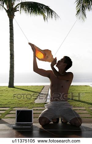 Man with a conch. View Large Photo Image Stock Photography - Man with a conch.. Fotosearch