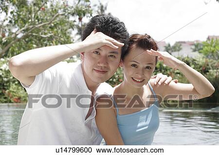 View of a couple shielding eyes. View Large Photo Image Stock Image - View of a couple shielding eyes.. Fotosearch