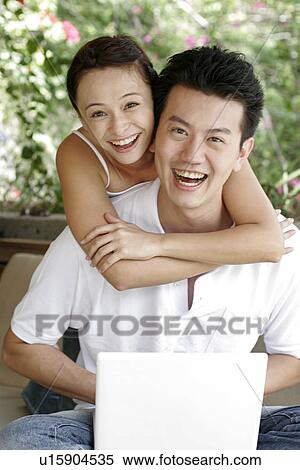 View of a couple with a laptop. View Large Photo Image Stock Photography - View of a couple with a laptop.. Fotosearch