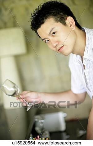 View of a man holding glass. View Large Photo Image Picture - View of a man holding glass.. Fotosearch