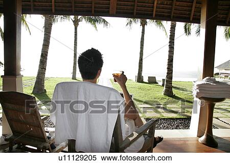 View of a man sitting on a chair. View Large Photo Image Stock Photography - View of a man sitting on a chair.. Fotosearch