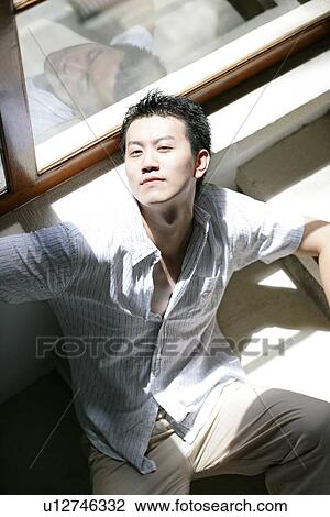View of a man sitting on a staircase. View Large Photo Image Stock Image - View of a man sitting on a staircase.. Fotosearch