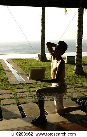 View of a man with a laptop. View Large Photo Image Stock Image - View of a man with a laptop.. Fotosearch