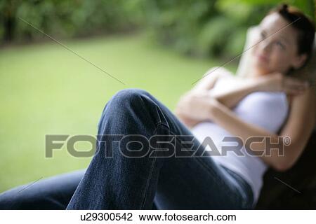 View of a woman lying on a bench. View Large Photo Image Stock Image - View of a woman lying on a bench.. Fotosearch