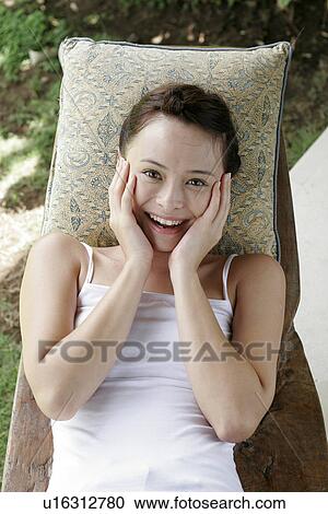 Stock Image - View of a woman smiling.. Fotosearch