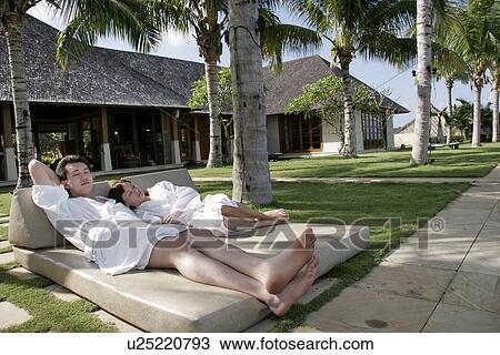 Stock Image - View of a young couple relaxing.. Fotosearch