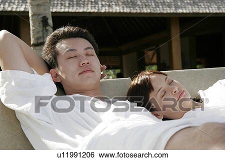 View of a young couple relaxing. View Large Photo Image Stock Photograph - View of a young couple relaxing.. Fotosearch